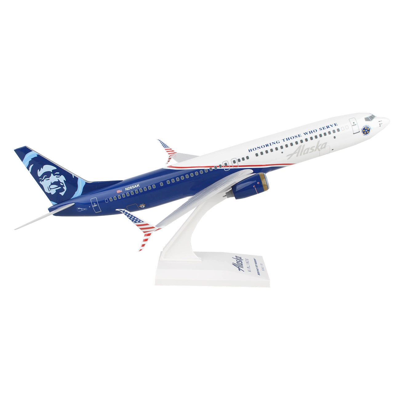 The Daron Alaska Airlines Boeing 737-900 Veterans 1:130 Model showcases the Honoring Those Who Serve livery in blue and white, displayed elegantly on a white stand.