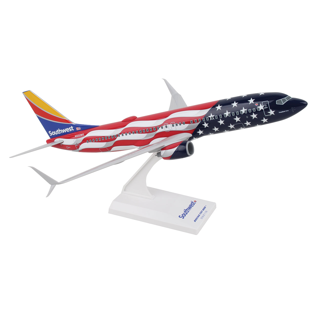 A collectors dream, the Daron Southwest Airlines Boeing 737-800 Freedom 1:130 Model features an American flag design with stars and stripes. It sits on a white stand displaying the airlines logo and name in stunning graphics.