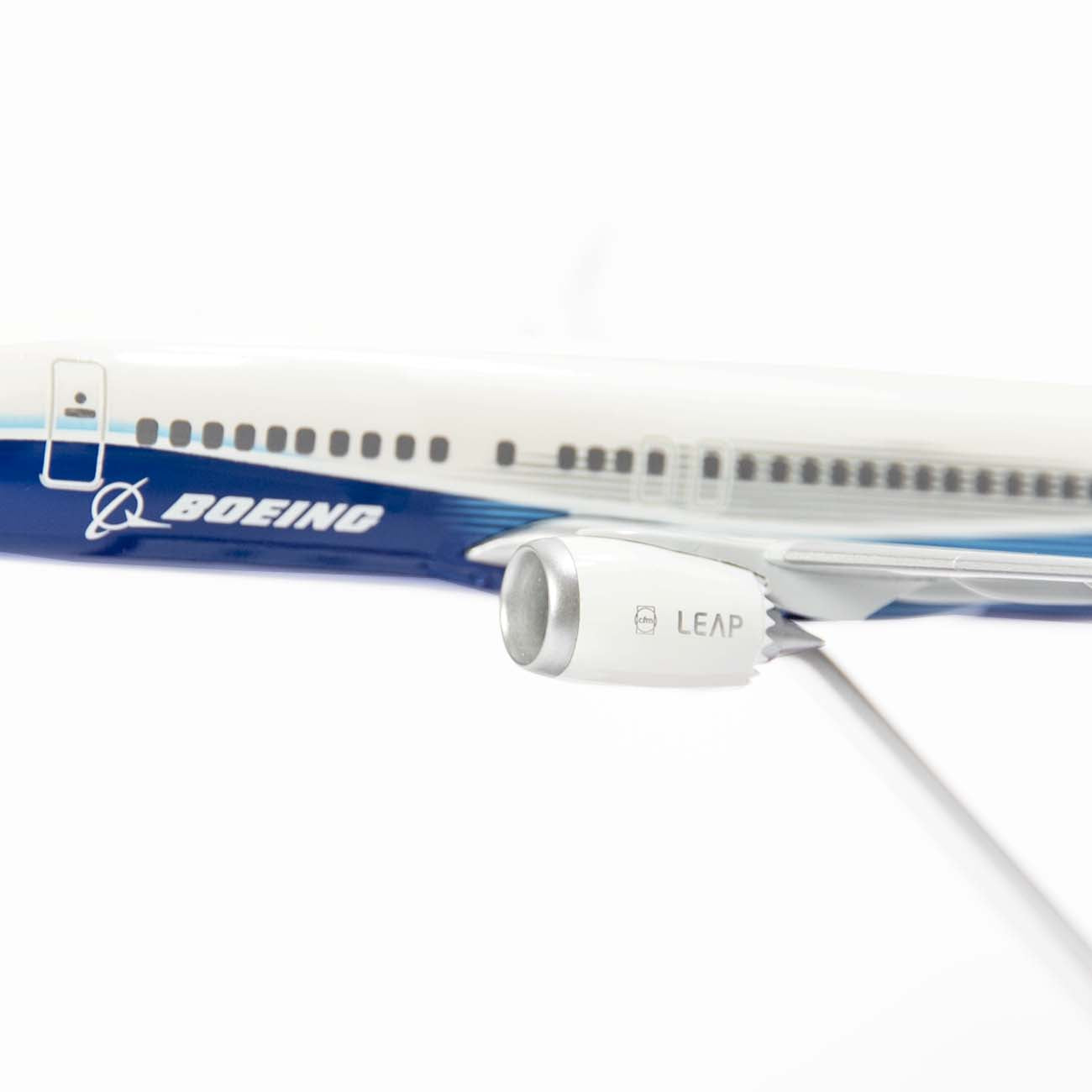 Close-up of the Boeing Unified 737 MAX 7 1:200 Model by The Boeing Store, highlighting the detailed, fuel-efficient LEAP engine with a metallic finish and intricate design elements on the fuselage, emphasizing the side view.