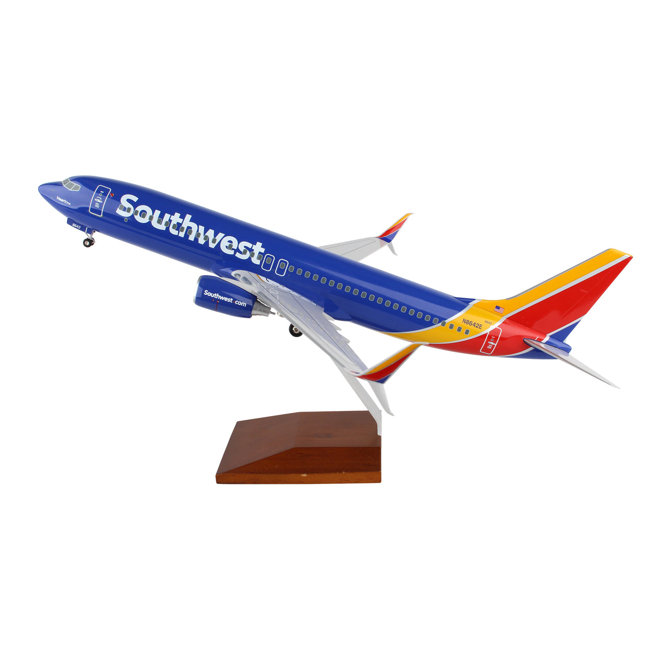 The Daron Southwest Airlines Boeing 737-800 1:100 Model features Southwests livery in blue, red, yellow, and orange. Its spinning engines enhance realism as it elegantly takes off from a wooden display stand.