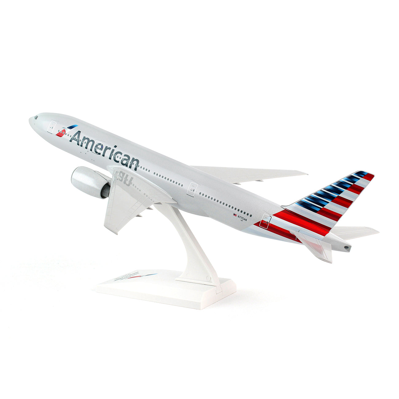 The Daron American Airlines Boeing 777-200 1:200 model features “American” on the side, a red, white, and blue striped tail, and comes mounted on a white display stand to appear as if taking off.