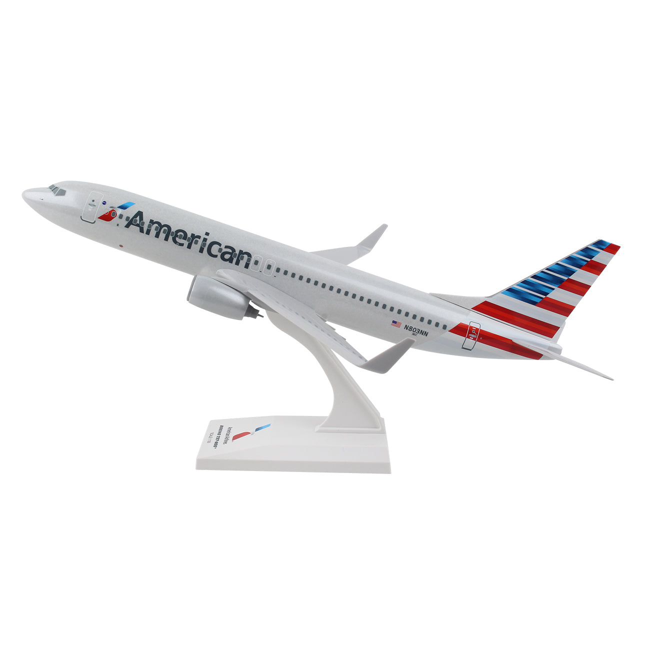 The Daron American Airlines Boeing 737-800 1:130 Model features detailed graphics with the airlines logo and red, white, and blue tail stripes. This true-to-scale model is mounted as if taking off, elegantly displayed on a white stand.