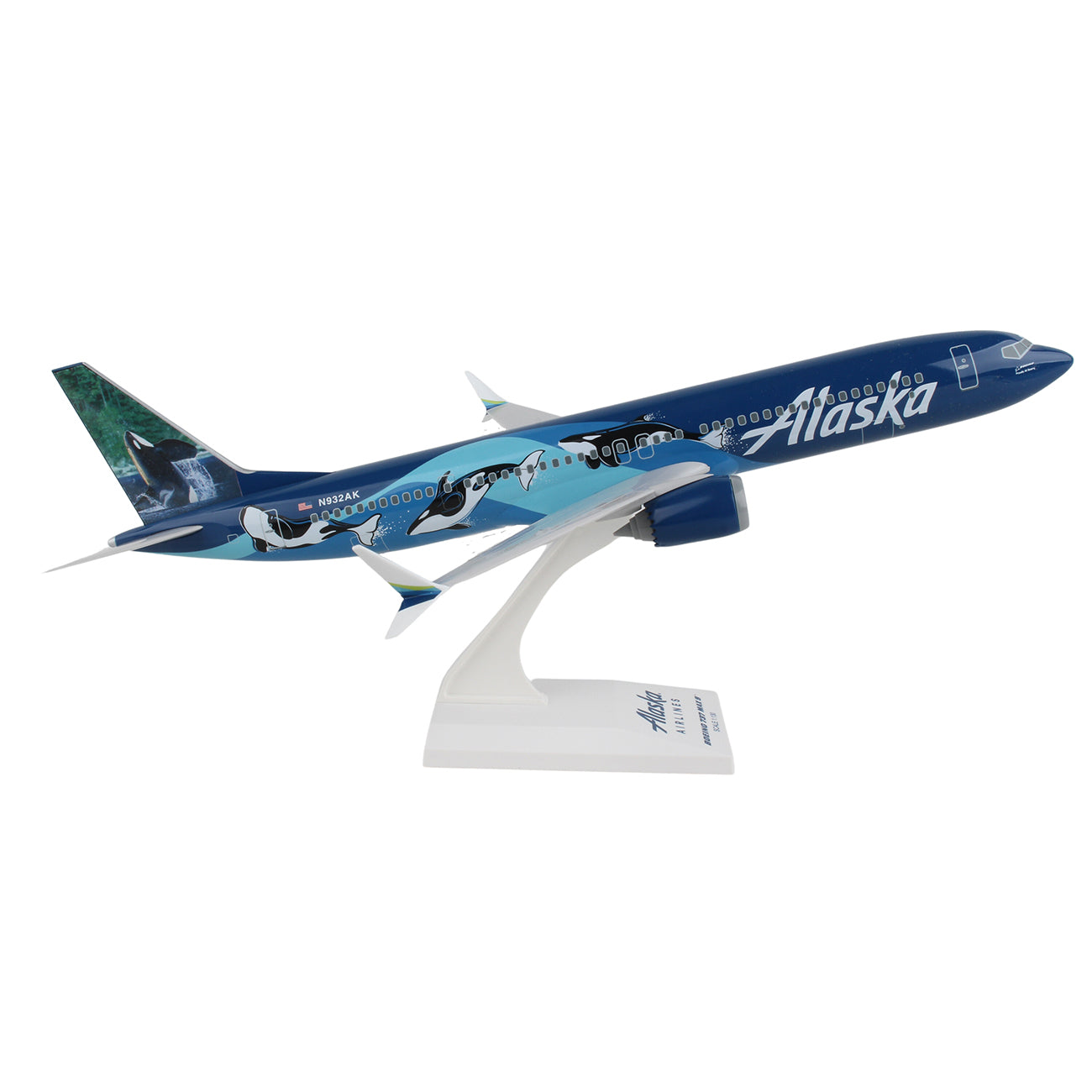 The Daron Alaska Airlines Orca Boeing 737 MAX 9 1:130 Model is showcased on a stand featuring an Alaska-themed design with orcas swimming on the dark blue fuselage and Alaska prominently displayed.