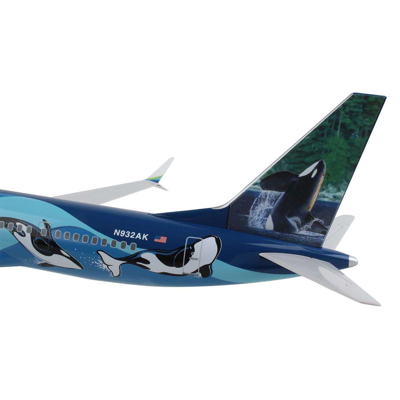 The Daron Alaska Airlines Orca Boeing 737 MAX 9 1:130 Model features a blue and white design with orca whales and displays N932AK. The tail highlights an orca breaching against a green forest backdrop.