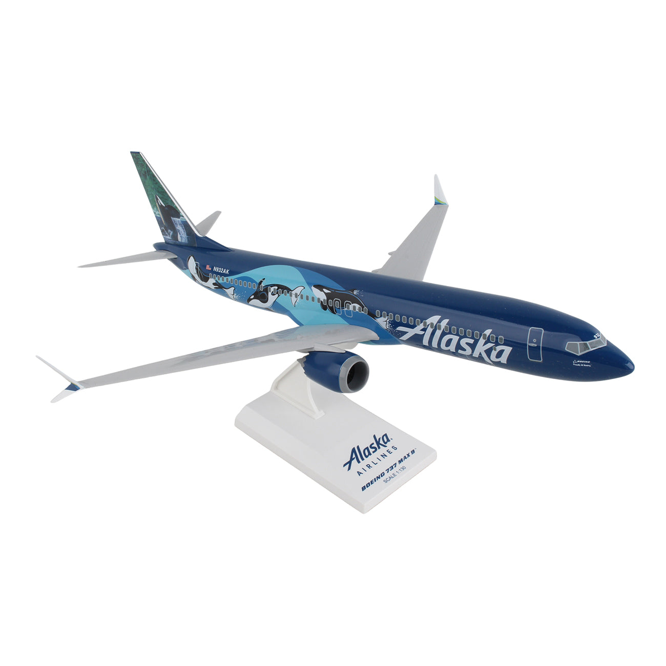 The Daron Alaska Airlines Orca Boeing 737 MAX 9 1:130 Model showcases a striking blue and white design featuring orcas, elegantly displayed on its Alaska-labeled stand.