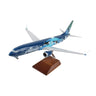 The Daron Alaska Airlines Boeing 737 MAX 9 1:100 Model features a blue and teal orca whale livery and comes mounted on a wooden display stand.