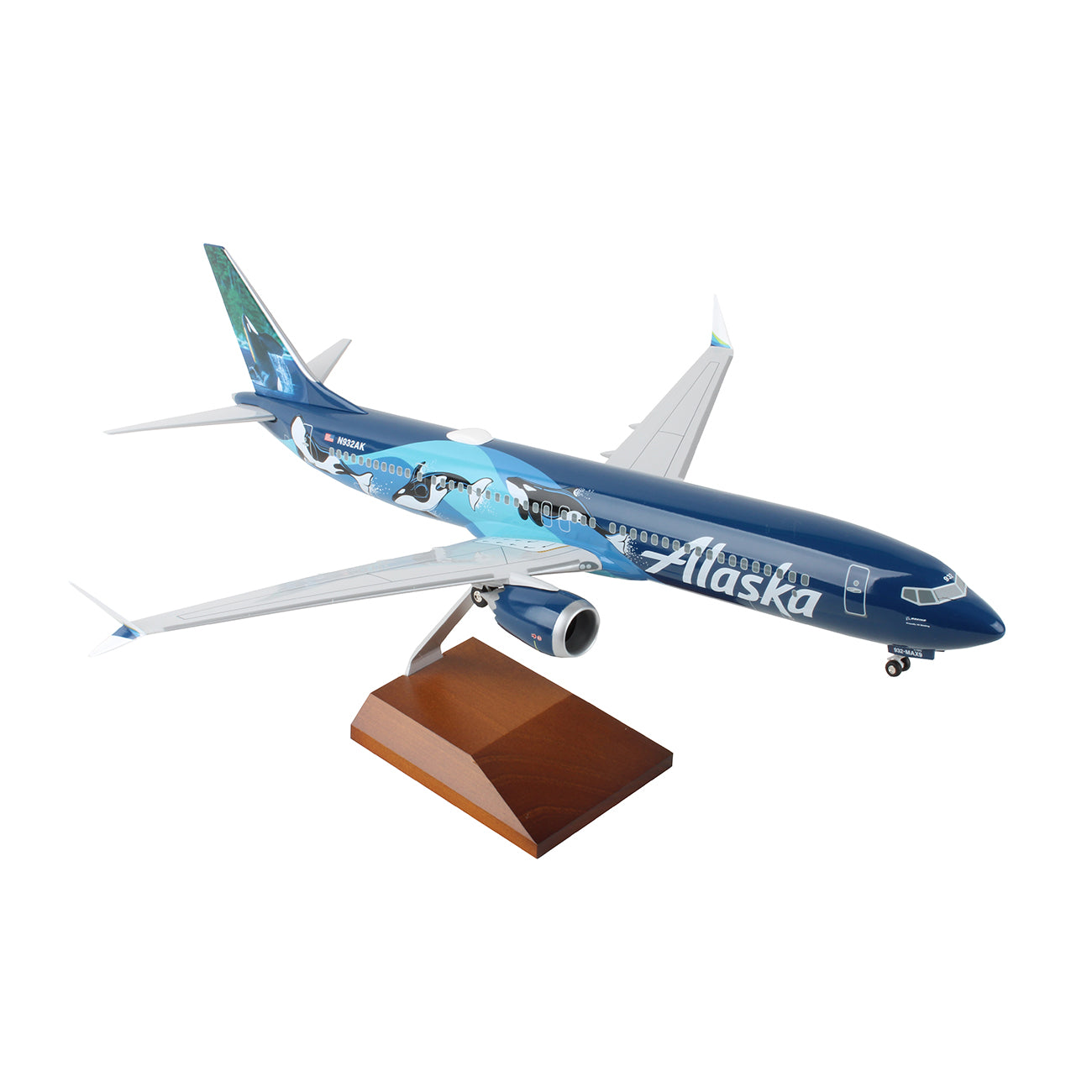 The Daron Alaska Airlines Boeing 737 MAX 9 1:100 Model showcases a blue livery with wildlife art and comes with a wooden stand—an ideal collectible for aviation enthusiasts.