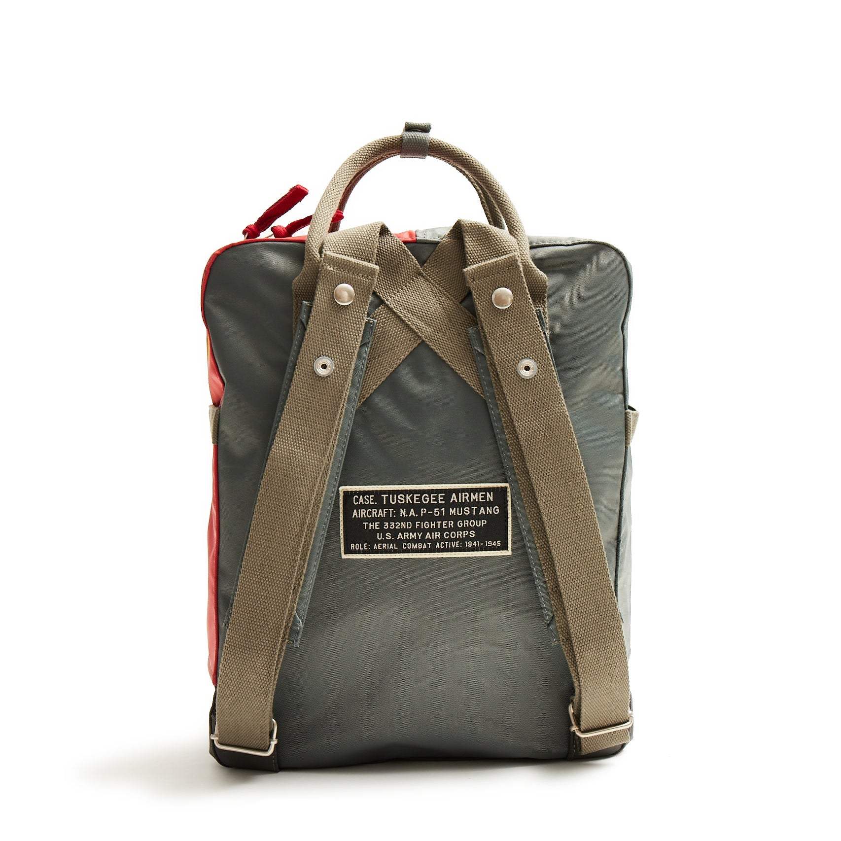 Introducing The Boeing Stores Red Canoe Tuskegee Red Tails Backpack—a stylish tribute with vintage flair. Made from durable nylon, it boasts dark green fabric, tan straps, bold red accents, a Tuskegee Airmen patch, and offers top handles and adjustable shoulder straps for comfort.