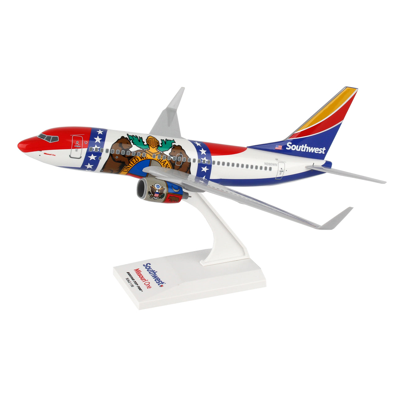 Collectors will adore Darons Southwest Airlines Boeing 737-700 Missouri One 1:130 Model, showcasing a colorful design with vibrant red, blue, and white hues featuring a bear and star motif. It comes mounted on a stand proudly displaying the Southwest logo.