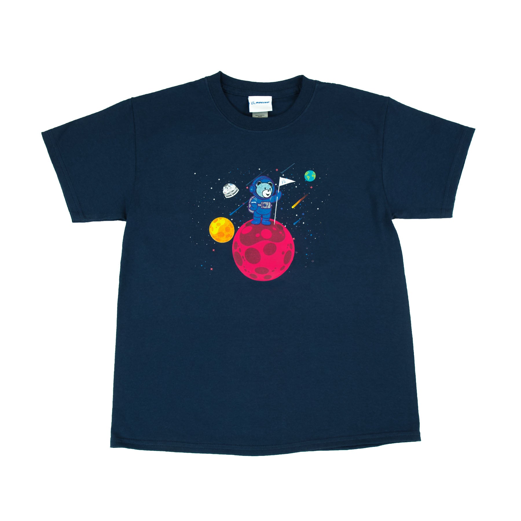The Boeing Stores Boeing Bear Kids T-Shirt features a navy blue cartoon astronaut relaxing on a red planet, surrounded by colorful planets and stars. The Space Explorers design includes a spaceship and comet in the background, ideal for budding adventurers.