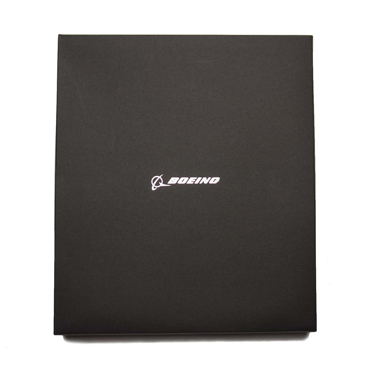 The Boeing Stores sleek black Small Padfolio With Wireless Power Bank elegantly displays the white Boeing logo and text, standing out against a plain white background, adding a touch of professionalism to your documents and essentials.