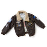 The Boeing Stores Boeing Kids Brown Aviator Jacket features a shearling-fleece collar, aviation-themed patches on the front, sleeves, and shoulders, plus two front pockets.