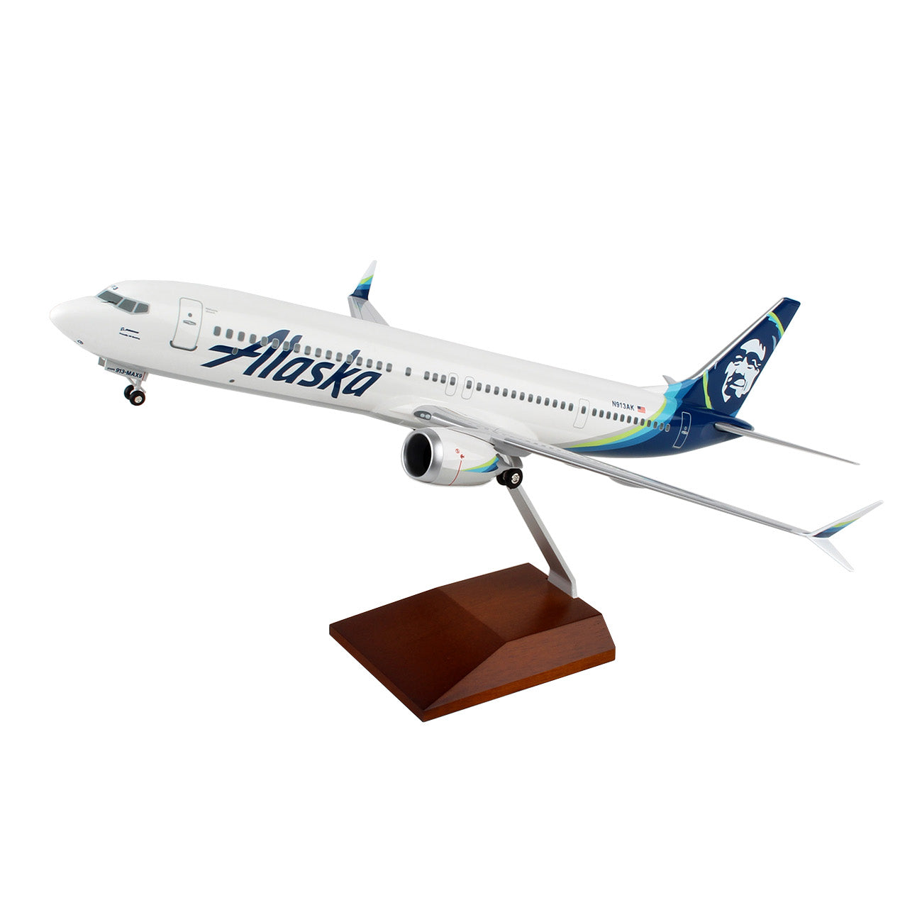 The Daron Alaska Airlines Boeing 737 MAX 9 1:100 Model features the airlines logo and signature colors on the tail and fuselage, includes a wooden stand, and requires some assembly.