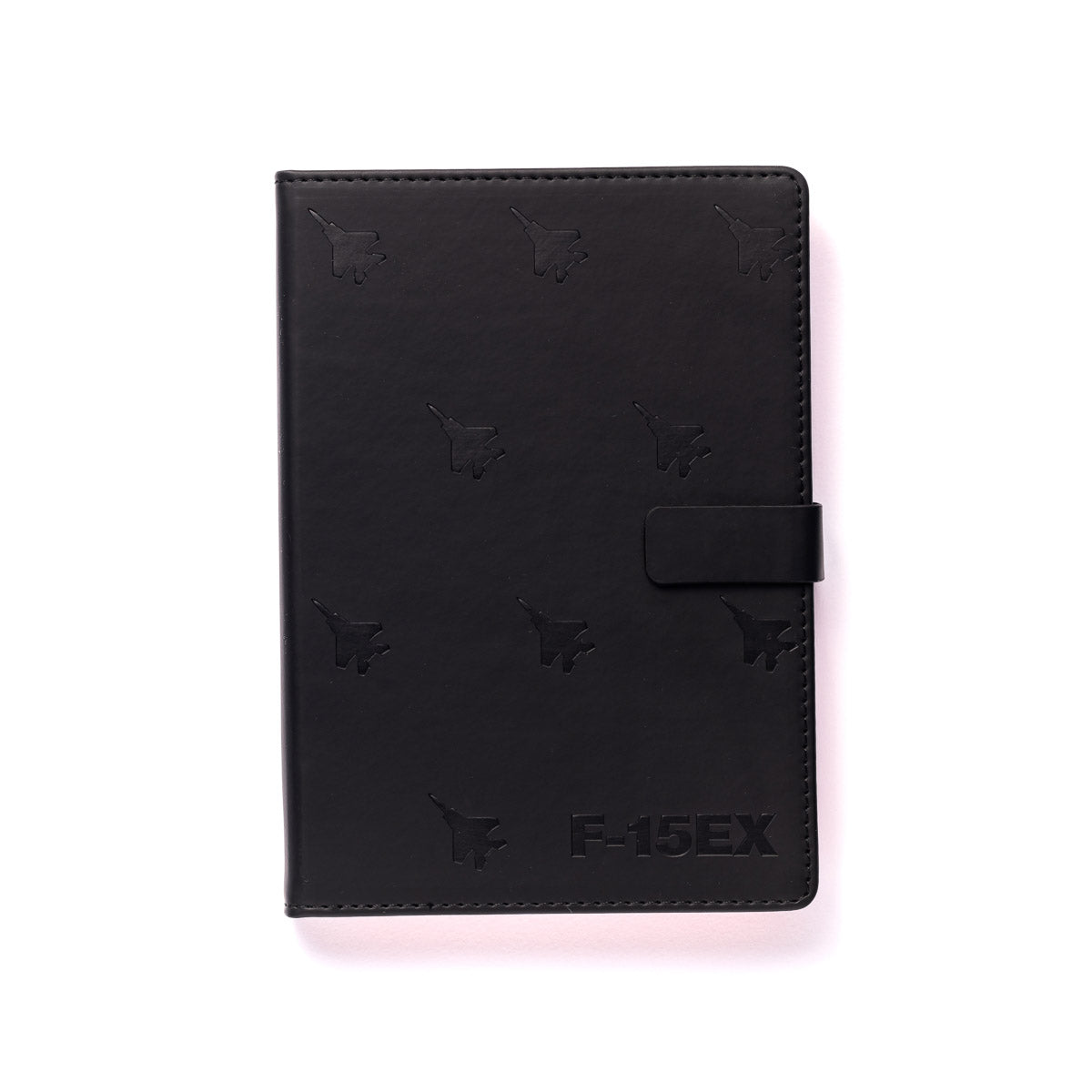 The Boeing Stores Boeing F-15EX Eagle Notebook has a black cover embossed with aircraft silhouettes and a F-15EX mark at the bottom right, featuring a strap closure.