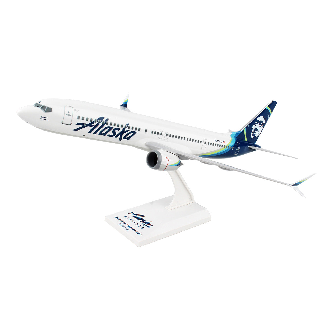 The Daron Alaska Airlines Boeing 737 MAX 9 1:130 Model features a white aircraft with Alaska on the side and a tail design showcasing a face. Ideal for collectors, it stands on a base labeled with the airlines logo.