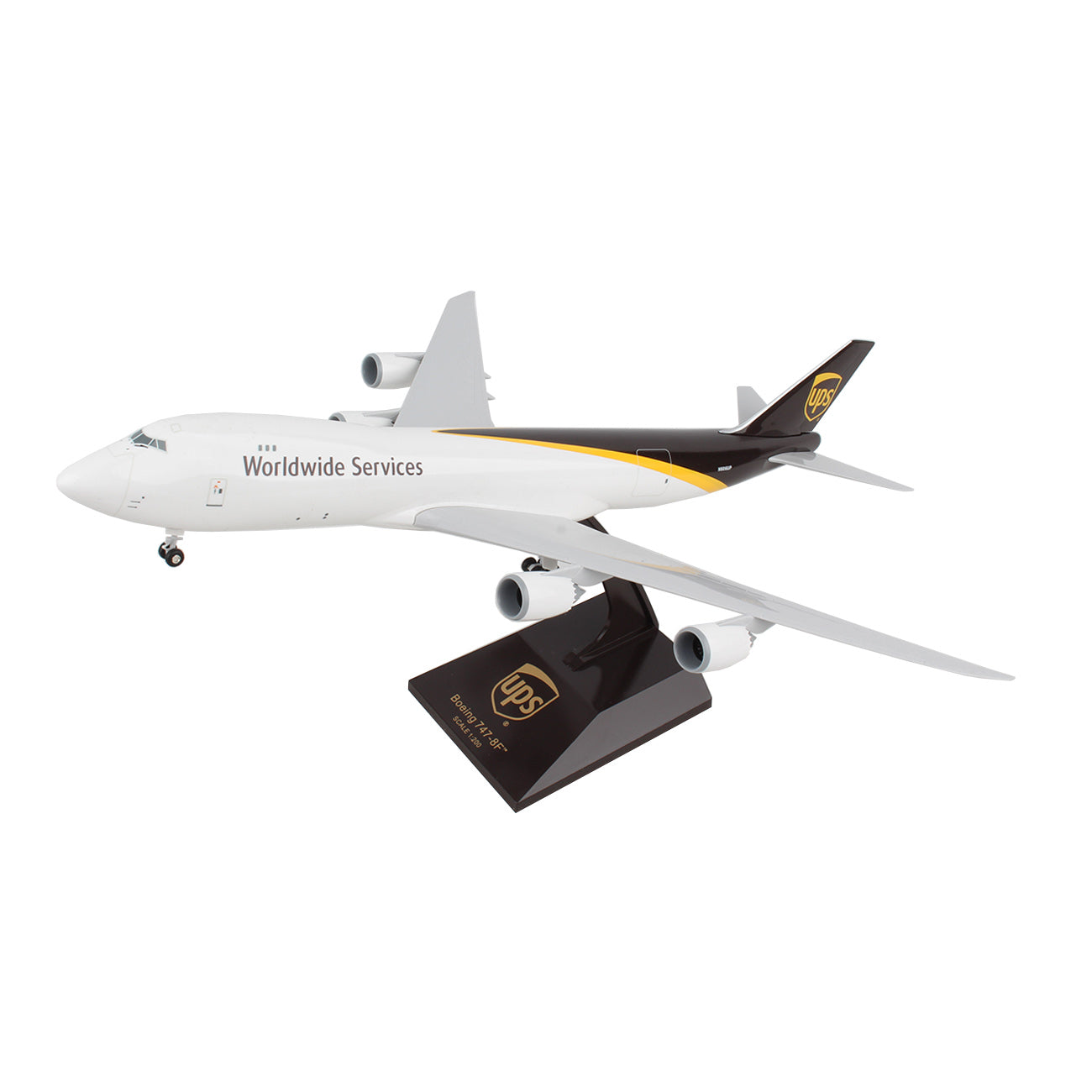 The Daron UPS Boeing 747-8F 1:200 model features the UPS livery with Worldwide Services text, a black stand with UPS logo, and detailed white, brown, and gold design, accurately representing a UPS cargo jet.