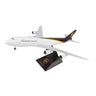 The Daron UPS Boeing 747-8F 1:200 model features the UPS livery with Worldwide Services text, a black stand with UPS logo, and detailed white, brown, and gold design, accurately representing a UPS cargo jet.