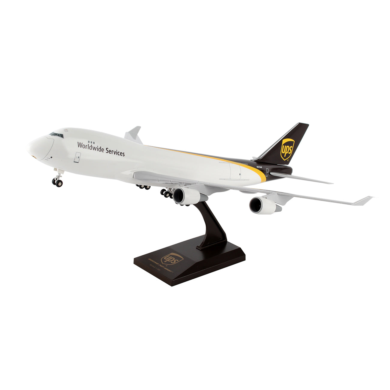 The Daron UPS Boeing 747-400F 1:200 model showcases a white body, brown tail with the UPS logo, and Worldwide Services on its side. Crafted from injection-molded plastic, its mounted on a black stand with a plaque against a white backdrop.