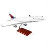 The Daron Delta Air Lines Boeing 747-400 1:100 model features a white body with blue and red accents, the Delta logo, four engines, and comes mounted on a wooden stand—perfect for collectors.
