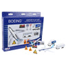 The Boeing Commercial Playset from The Boeing Store includes a die-cast metal 787 Dreamliner toy, buses, a luggage cart, and airport signs. These toys are displayed in a plastic case inside a blue and white box with product details and branding.