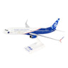 The Daron Alaska Airlines Boeing 737-900 Veterans 1:130 Model features red, white, and blue livery with HONORING THOSE WHO SERVE, the Alaska Airlines logo, a face on the tail, and comes mounted on a white display stand.